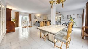 a kitchen and dining room with a table and chairs at Costacabana - Villa Miro in Lloret de Mar