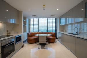a kitchen with a table and chairs and a sink at The Diplomat Radisson Blu Residence in Manama