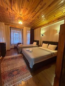 a bedroom with two beds and a wooden ceiling at NarPera Taksim Boutique Hotel in Istanbul