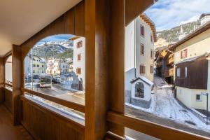 a window with a view of a city at Ciasa de Vich in Vigo di Fassa