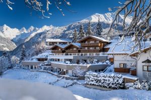 a resort in the mountains covered in snow at Alpin Chalet am Burgsee in Ladis