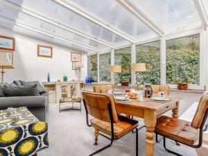a conservatory living room with a table and chairs at 2 Bed in Talybont-on-Usk BN249 in Talybont