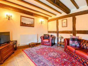 a living room with two red couches and a tv at 3 Bed in Abergavenny BN324 in Abergavenny