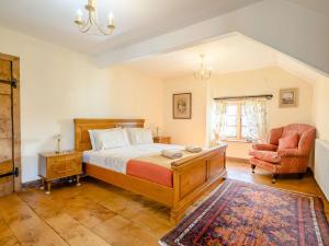 a bedroom with a bed and a chair at 3 Bed in Abergavenny BN324 in Abergavenny