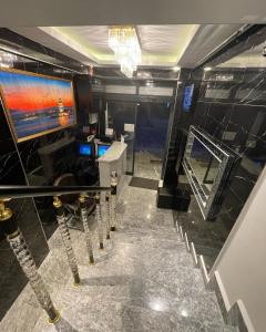 a room with a staircase with a television and a mirror at Aram Edessa Hotel in Istanbul