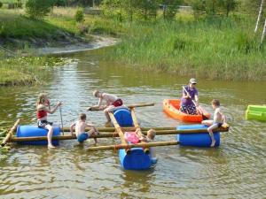 a group of people on rafts in a river at Minicamping Falkenborg in Beltrum