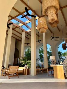 a patio with chairs and chandeliers at Eden Resort & Villas in Patong Beach