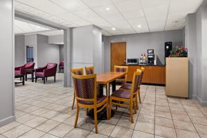 a dining room with a table and chairs at Red Roof Inn & Suites Monroe, NC in Monroe