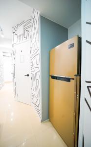a refrigerator in a room with a drawing on the wall at Student Accommodation - 292 Hennessy Road in Hong Kong