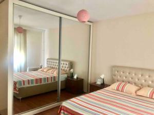 a bedroom with two beds and a large mirror at Choice of Satisfaction in a Quality Neighborhood in Istanbul