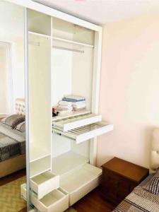 a white cabinet in a bedroom with a bed at Choice of Satisfaction in a Quality Neighborhood in Istanbul