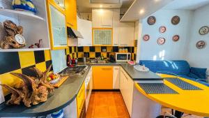 a kitchen with a counter and a yellow and black at Edelweiss - Maison dOc in Oulx +9 photos