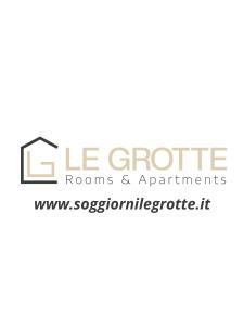 un cartello che legge le groupie camere e appartamenti di Rosso Conero - Le Grotte Rooms & Apartments a Camerano