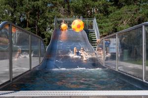 a slide in the water with two people on it at Recreatie- en Natuurpark Keiheuvel in Balen