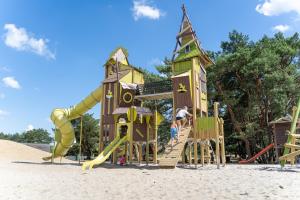 a playground with a slide in the sand at Recreatie- en Natuurpark Keiheuvel in Balen