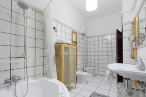 a bathroom with a tub and a sink and a toilet at Beautiful apartment with amazing Rooftop&Jacuzzi in Rome +23 photos