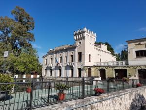 a white building with a clock tower on top at Domus Lineker in Venafro