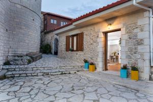 a brick house with a door and a patio at Koukou Spitiko in Dimitsana