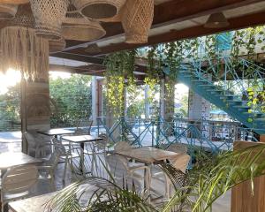 un restaurante con mesas y sillas y una escalera en MuchoSur Manzanillo CTG, en Cartagena de Indias