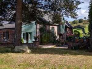 a house with a tree in front of it at 1 Bed in Hay-on-Wye 81312 in Talgarth