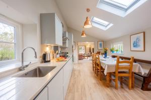 a kitchen and dining room with a table and chairs at The Pottage in Hoxne