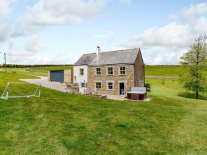 an old brick house in a field with a goal at 4 Bed in Looe 82662 in Lanreath