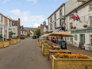 a street with tables and umbrellas on a city street at 1 bed in Crickhowell 82777 in Crickhowell