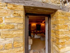a doorway into a room with a stone wall at 1 Bed in Longborough 82284 in Longborough