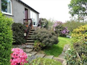 a stairway leading to a house with flowers at 1 Bed in Kirkby-in-Furness SZ463 in Grizebeck