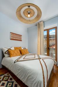 a bedroom with a large bed and a chandelier at Koukou Spitiko in Dimitsana
