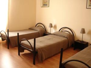 A bed or beds in a room at Star Hostel