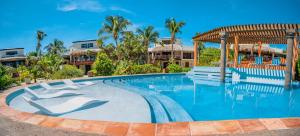 a swimming pool at a resort with palm trees at La Perla del Caribe - Villa Ruby in San Pedro