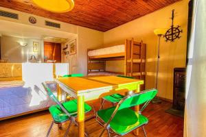 a room with a table and chairs and a bed at Appartamento La Chapelle Chaberton - Affitti Brevi Italia in Sauze dʼOulx