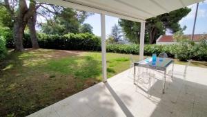 a table on a patio with a view of a yard at Appartamento Cod 466 - Taunus Vacanze in Numana