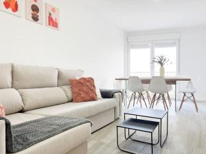 a living room with a couch and a table at Apartamentos Gredos 202 in Jaraiz de la Vera