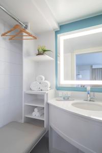 a bathroom with a sink and a mirror at Sanibel Island Beach Resort in Sanibel