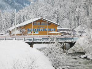 a house on a bridge in the snow at Schelpenalp Berghotel Balderschwang in Balderschwang