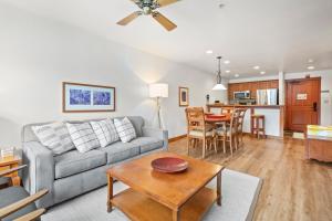 a living room with a couch and a table at Eagle Springs West 403: Blackbird Suite in Solitude