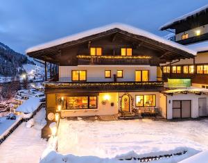 a house in the snow in the winter at Pension St.Leonhard in Bad Gastein