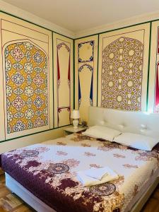 a bedroom with a bed with two towels on it at "CHOR MINOR" BOUTIQUE HOTEL UNESCO HERITAGE List Est-Since 2003 in Bukhara