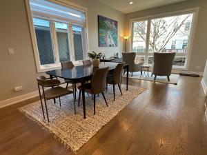 a dining room with a dining table and chairs at Modern SFH Near McCormick Place & Soldier Field in Chicago