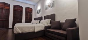 a bedroom with a bed and a couch at TREASURE HUNTER At Heritage Georgetown in George Town