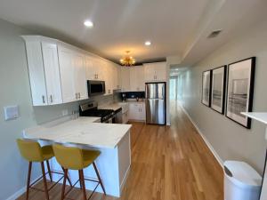 a kitchen with white cabinets and a white counter top at Modern Wrigley Oasis with Parking! in Chicago