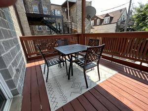 a wooden deck with a table and chairs on a balcony at Modern Wrigley Oasis with Parking! in Chicago