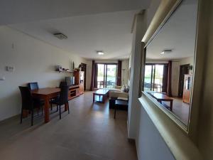 a living room with a table and a dining room at Mar de Pulpí Costa de Almeria by Mar Holidays in San Juan de los Terreros +37 photos