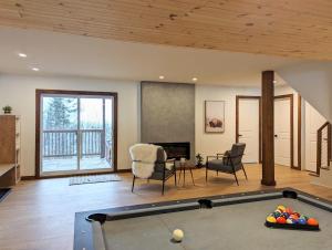 a living room with a pool table at Ski in Tremblant and Mont Blanc, Views, Spa and Pool table in Saint-Faustin