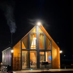 a house with a light on the roof at night at Shpija e Liqenit in Pristina