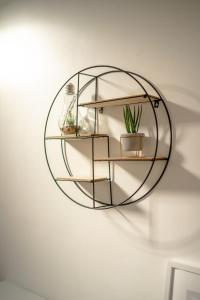 a glass shelf on a wall with potted plants at Enjoy a Luxury & Peaceful Home in Loughton, Essex in Loughton