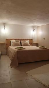 a bedroom with a large bed with two plates on it at Refúgio do Agricultor - Gerês in Montalegre