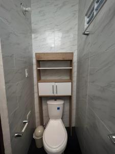a small bathroom with a toilet and a shower at Loft Vacacional in Mariquita +4 photos